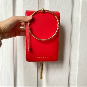 Brand New! Red clutch with golden tassel Charles & Keith